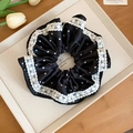 Elegant black scrunchie with white polka dots and lace trim on a decorative tray - Scrunchie / Black Satin Spots
