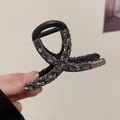 Dettaglio molletta per capelli nera con strass grigi scintillanti e finitura di classe - Stile con Strass Incrociati / Nero