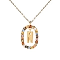 Macro detail of golden letter N pendant featuring vibrant multi-color zircon stones - Letter N