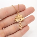 Golden Tree of Life necklace with infinity symbol pendant held for size scale - Tree of Life