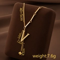 Golden titanium steel necklace with V letter pendant and tassel on velvet stand - Letter V / Gold