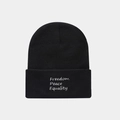 Close-up of black knit beanie featuring white embroidered Freedom Peace Equality text - Three-line Letter Embroidery / Black