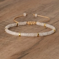 Adjustable woven bracelet with white matte stone beads and golden cylinder spacers - No.22 Clear Quartz