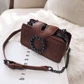 Brown vintage flap bag with metal studs and rhinestone buckle on white fur mat - Brown