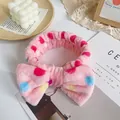 Detail of a plush pink bow headband with colorful polka dots in an aesthetic setting - Pink Circle with Colorful Dots