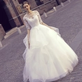 Elegant white lace wedding dress with long sleeves and layered tulle skirt in outdoor setting - US 2 / White Floor-length