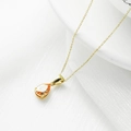Elegante gouden titanium stalen ketting met een druppelvormige oranje edelsteen hanger - Goud + Champagne Zirconia