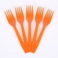 Halloween party tableware set featuring five bright orange plastic forks on white backdrop - 24 Orange Forks