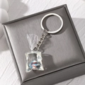 Macro shot of creative resin tropical fish water bag pendant with silver keychain ring - Colorful Fish