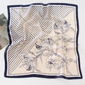 Detailed pattern of silk scarf showing blue geometric stripes and lily floral motifs - Striped Lily - Navy