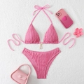 Pink ribbed bikini set with halter top and metal star pendants on white plush background - Pink