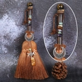 Detail of handmade witch broom with natural crystal stones and silver moon charm - Tiger's Eye