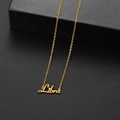 Minimalist gold Libra zodiac pendant necklace displayed on a black textured gift box - Libra Gold
