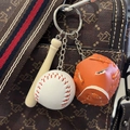 Mini baseball keychain set with wooden bat, white ball, and orange glove hanging on a bag - 3.5CM White Ball Orange