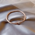 Close-up of rose gold bangle with pave diamonds on champagne satin background - Triple Circle Screw Motif Rose Gold (11# Bracelet-Gold)