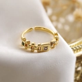 Macro shot of gold geometric ring with green and purple square zircons on white silk - Adjustable Open / 14226/Gold/Green & Purple Square Zircon