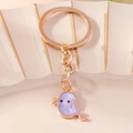 Close-up of a purple enamel ghost keychain with rose gold metal chain and hardware - Purple Ghost