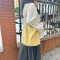 Lifestyle view of a yellow gingham canvas tote bag held by a model on a city street - Yellow Check