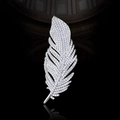 Elegant silver feather brooch with textured pavé finish against a dark reflective backdrop - Silver Sparkling Feather