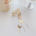 Golden metal hair claw clip with elegant butterfly tassel charms on a beige table - Model E Gold 8cm