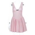 Detail of V-neckline with delicate black bow and lace trim on pink polka dot mini dress - XS / Pink