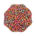 Perline di vetro colorate da 4mm con motivi variopinti in una ciotola bianca a fiore - 4mm / Serie Arancione