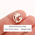 Polished stainless steel dolphin charm pendant shown on a fingertip for size reference - Dolphin-DY1080-1