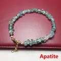 Macro shot of natural apatite chip stone bracelet with golden lobster clasp and chain - Apatite