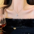 Elegant silver four-leaf clover pendant necklace with sparkling pavé zircons on model - Silver Micro-Inlaid Zirconia Flower