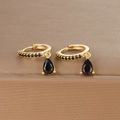 Macro detail of gold hoop earrings featuring black zircons and pear-shaped drop stones - Gold Black Zirconia