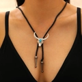Silver bull head bolo tie with turquoise stone on black woven cord worn by model - Blue Turquoise Cow Skull Bolo Tie (22 White K 6535)