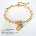 14K vergulde roestvrijstalen armband met blauw kristal en een leuk letter O bedeltje - Letter O / Staalkleur