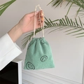 Mint green corduroy drawstring pouch with a black smiley face print for storage - Grass Green Smiley Face
