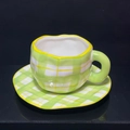 Irregular ceramic coffee cup and saucer set with green and white grid pattern - Green Checkered Cup & Saucer