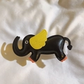 Detail of a handmade black leather elephant charm with yellow wings and orange feet accents - Back Clip Only / Black