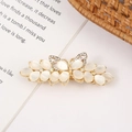 Detailed close-up of a gold floral hair clip with opal stones and sparkling crystals - Style 7 Small Butterfly