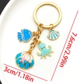 Blue ocean-themed keychain with starfish and jellyfish charms in gold-tone finish - Lake Blue Shell Jellyfish Keychain-LS561
