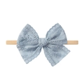 Infant headband featuring a blue hollow lace bow on a soft beige elastic band - Beige