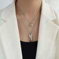Double-layered silver necklace set featuring heart lock and key pendants on a model - Silver Lock and Key Necklace Set