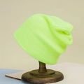 Detail view of the fluorescent green ribbed knit beanie on a vintage wooden stand - Neon Yellow