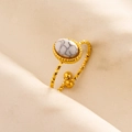 Detail of adjustable gold ring featuring white marble stone and diamond-cut textured band - Gold Base-White Marble Stone