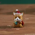 Miniature Christmas fox figurine wearing a Santa hat and holding a blue gift box - Fox (Kraft Box)