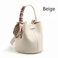 Creamy white lychee grain bucket bag with silk scarf handle and golden metal hardware - Off White