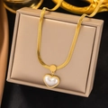 Detailed macro shot of a golden flat snake chain necklace with a heart pearl pendant - Heart Artificial White Shell Snake Chain (AH6154) / Gold
