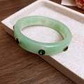 Light green acrylic rhinestone bracelet with gold setting on stone display - Light Green