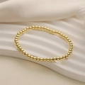 Minimalist gold beaded elastic bracelet with heart key pendant on white silk fabric - 4mm Copper Beads