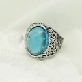 Macro shot of vintage silver ring with oval sky blue gemstone and floral engravings - Steel Band + Blue Stone