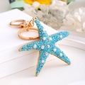 Close-up of ocean series starfish keychain with blue rhinestones and gold plating - Starfish 5 (Blue)