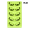 Detailed close-up of five pairs of 3DY88 fox-eye cat-eye false eyelashes on a green tray - Extended End Style (3DY88)