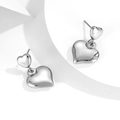 Minimalist silver double heart stud earrings on a geometric display, sleek modern jewelry - Silver
